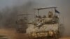 A convoy of Israeli tanks maneuvers near Israel's border with Gaza, amid the ongoing conflict between Israel and the Palestinian Islamist group Hamas, in Israel, Dec. 4, 2023.