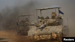 A convoy of Israeli tanks maneuvers near Israel's border with Gaza, amid the ongoing conflict between Israel and the Palestinian Islamist group Hamas, in Israel, Dec. 4, 2023.