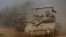 A convoy of Israeli tanks maneuvers near Israel's border with Gaza, amid the ongoing conflict between Israel and the Palestinian Islamist group Hamas, in Israel, Dec. 4, 2023.