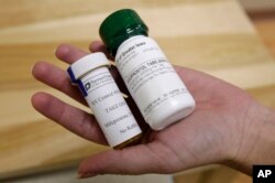 FILE - Bottles of the abortion pills mifepristone, left, and misoprostol are seen at a clinic in Des Moines, Iowa, Sept. 22, 2010.