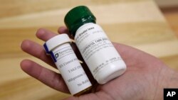 FILE - Bottles of the abortion pills mifepristone, left, and misoprostol are seen at a clinic in Des Moines, Iowa, Sept. 22, 2010.
