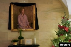 A black sash hangs over a portrait of former U.S. first lady Rosalynn Carter, who died in Georgia, at the White House in Washington, Nov. 27, 2023.