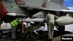 RAF weapon technicians prepare a RAF Typhoon FRG4 aircraft to conduct further strikes against Houthi targets, Feb. 3, 2024. Cpl Samantha Drummee/UK MOD/Handout via REUTERS 