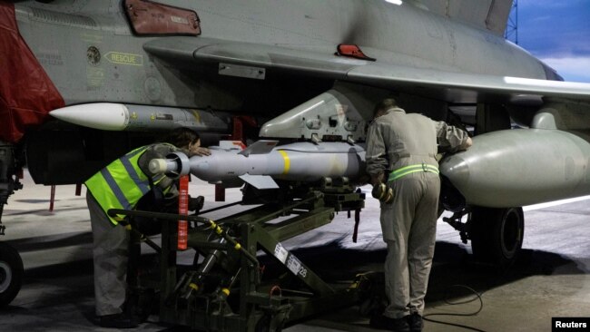 RAF weapon technicians prepare a RAF Typhoon FRG4 aircraft to conduct further strikes against Houthi targets, Feb. 3, 2024. Cpl Samantha Drummee/UK MOD/Handout via REUTERS