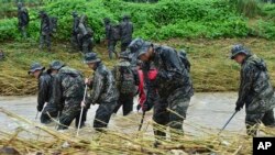 South Korean marines search for missing people in floodwaters in Yecheon, South Korea, July 18, 2023. 