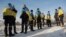 Newly-swapped Ukrainian prisoners of war, with Ukrainian national flags draped around their shoulders, are seen after an exchange for Russian POWs at an unspecified location on the Ukraine-Russia border, Jan. 31, 2024. 