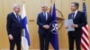 Finnish Foreign Minister Pekka Haavisto, left, speaks with U.S. Secretary of State Antony Blinken, right, and NATO Secretary General Jens Stoltenberg during a meeting of NATO foreign ministers at NATO headquarters in Brussels, April 4, 2023.