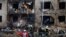 Firefighters work at the site of a residential building damaged during a Russian missile attack in Kyiv, Ukraine, Jan. 2, 2024