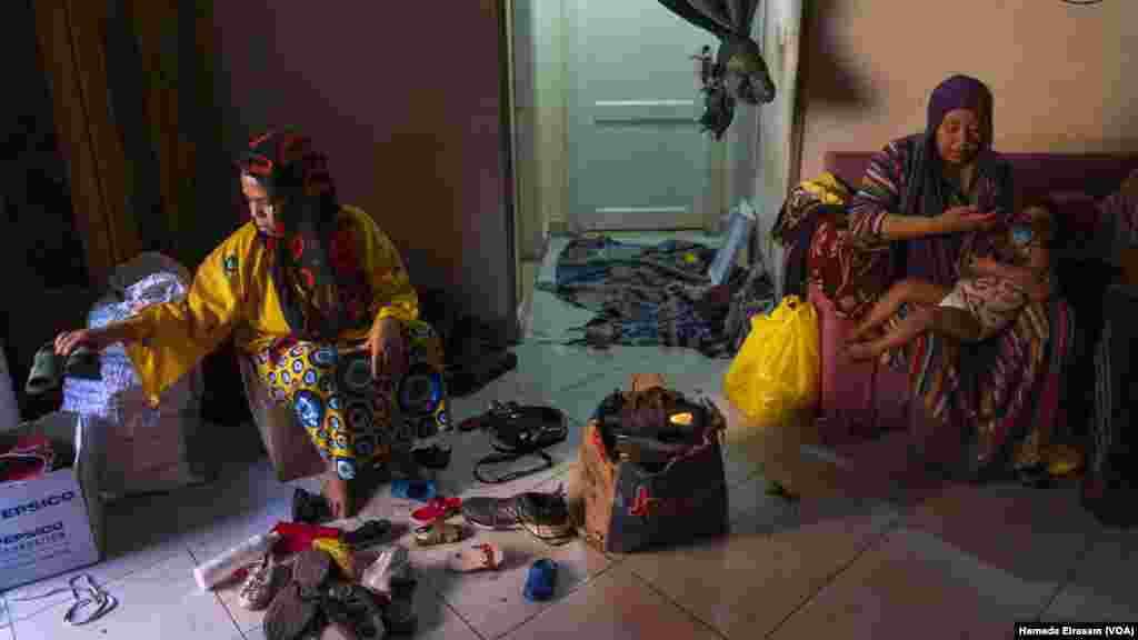 Salma, a mother of three, searches through used shoes for a pair to wear during the holiday. &ldquo;My kids are young, but they understand what it means to be poor,&rdquo; she says, &ldquo;like when they see other kids with new outfits for Eid.&rdquo;