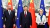 FILE - Chinese President Xi Jinping, center, stands with European Commission President Ursula von der Leyen and European Council President Charles Michel in Beijing, Dec. 7, 2023. China is making efforts to relieve recent tensions between it and the EU.
