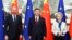 FILE - Chinese President Xi Jinping, center, stands with European Commission President Ursula von der Leyen and European Council President Charles Michel in Beijing, Dec. 7, 2023. China is making efforts to relieve recent tensions between it and the EU.
