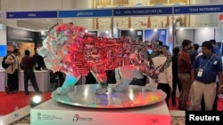 FILE - Visitors stand next to a "Make In India" logo during a three-day semiconductor event in Bengaluru, India, April 30, 2022. Japan and India signed an agreement July 20, 2023, to jointly develop semiconductors