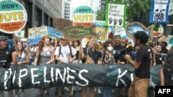 Protesters march in Manhattan, New York, demanding that Biden ends new fossil fuel projects, ahead of United Nations General Assembly and U.N. Climate Ambition Summit on Sunday, Sept. 17, 2023. 