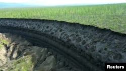 A view of the Batagaika crater, as permafrost thaws causing a mega-slump in the eroding landscape, in Russia's Sakha Republic in this image from video taken July 11 or 12, 2023. 