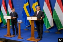 FILE — Sweden’s Prime Minister Ulf Kristersson, left, listens to his Hungarian counterpart, Viktor Orban, during a press conference at the Carmelite Monastery in Budapest, Hungary, Feb. 23, 2024.