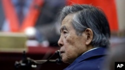 FILE - Peru's former President Alberto Fujimori listens to a question during his testimony in a courtroom at a military base in Callao, Peru, March 15, 2018.