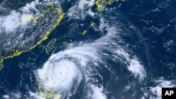 This satellite image taken by Himawari-8, a Japanese weather satellite, and provided by National Institute of Information and Communications Technology, shows Typhoon Doksuri near the northern Philippines, July 25, 2023. 