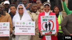 Protesters carry placards lauding marriages between a man and a woman, in Blantyre, Malawi, July 13, 2023. (Lameck Masina/VOA)