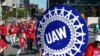 FILE - United Auto Workers members walk in the Labor Day parade in Detroit, Sept. 2, 2019. 