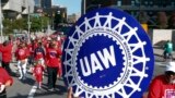 FILE - United Auto Workers members walk in the Labor Day parade in Detroit, Sept. 2, 2019. 