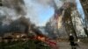 A firefighter looks at an apartment building and cars that burn after a Russian air strike, amid Russia's attack on Ukraine, in Kharkiv, Ukraine, Aug. 30, 2024.