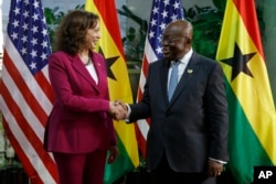 Vice President Kamala Harris is welcomed by Ghana President Nana Akufo-Addo in Accra, March 27, 2023.