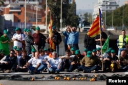 Spanish farmers block access to the Castellon port during a protest against high costs, bureaucracy and competition from non-EU countries, in Castellon, Spain, Feb. 7, 2024.