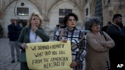 FILE - Members of the Armenian community protest a contentious deal that stands to displace residents and hand over a large section of the Armenian Quarter in the Old City of Jerusalem, May 19, 2023. 