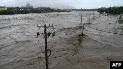 This picture shows a view of the overflooded Yongding river, after heavy rains in Mentougou district in Beijing on July 31, 2023.