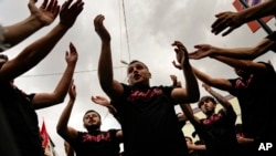 Shiite Muslims beat their chests during the Ashoura mourning ritual, in Istanbul, Turkey, July 28, 2023. 