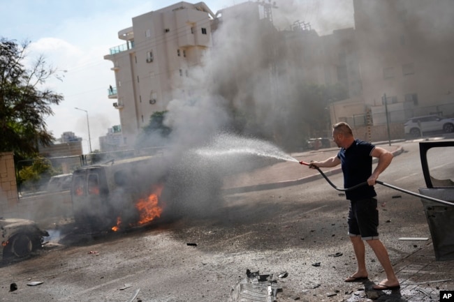 Cars are on fire after they were hit by rockets from the Gaza Strip in Ashkelon, Israel, on Oct. 7, 2023. (AP Photo/Ohad Zwigenberg, File)