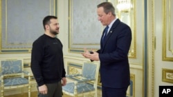 FILE - In this photo provided by the Ukrainian Presidential Press Office on Nov. 15, 2023, Ukrainian President Volodymyr Zelenskyy, left, speaks with British Foreign Secretary David Cameron during their meeting in Kyiv, Ukraine. 