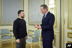 In this photo provided by the Ukrainian Presidential Press Office on Wednesday, Nov. 15, 2023, Ukrainian President Volodymyr Zelenskyy, left, speaks with Britain's Foreign Secretary David Cameron on the occasion of their meeting, in Kyiv, Ukraine.