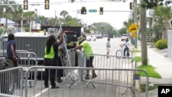 On April 16, 2024, just days before the Orange Crush weekend beach party, a worker set up a section of metal barricade on a main thoroughfare in Tybee Island, Georgia.