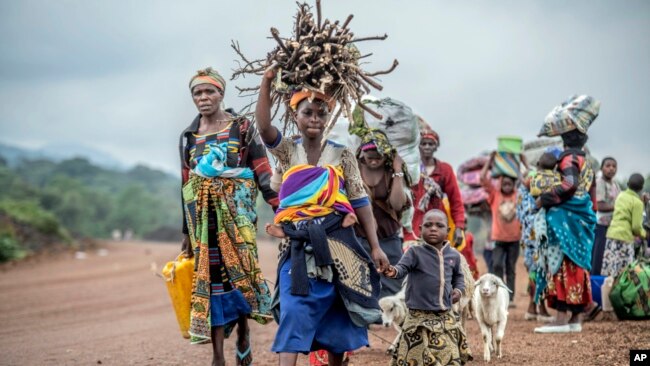 FILE - Residents flee fighting between M23 rebels and Congolese forces near Kibumba, some 20 kilometers north of Goma, Democratic Republic of Congo, on Oct. 29, 2022.