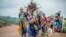 FILE - Residents flee fighting between M23 rebels and Congolese forces near Kibumba, some 20 kilometers north of Goma, Democratic Republic of Congo, on Oct. 29, 2022. 