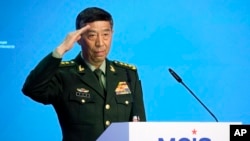 FILE - Chinese Defense Minister Li Shangfu salutes as he arrives to deliver his speech in Moscow, Russia, Aug. 15, 2023.