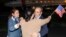 Family members embrace freed American Emad Shargi after he and four fellow detainees were released in a prisoner swap deal between U.S and Iran, and arrived at Fort Belvoir, Virginia, Sept. 19, 2023.