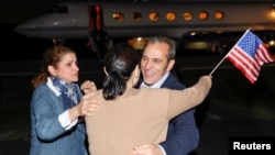 FILE - Family members embrace freed American Emad Shargi after he and four fellow detainees were released in a prisoner swap deal between the U.S and Iran, at Fort Belvoir, Virginia, Sept. 19, 2023.