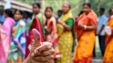 A woman shows her inked finger after casting her ballot to vote in the first phase of India's general election at a polling station in Kalamati village, Dinhata district of Cooch Behar in the country's West Bengal state.