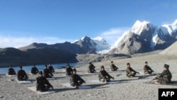 the Indian Army shows Indian soldiers of Trishakti corps celebrating the International Yoga Day at Gurudongmar Lake,