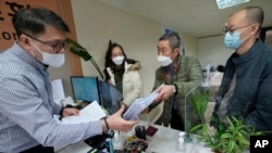 FILE - FILE - Peter Møller, second from right, attorney and co-founder of the Danish Korean Rights Group, submits the documents at the Truth and Reconciliation Commission in Seoul, South Korea, Nov. 15, 2022.