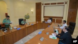 In this photo released from the The Military True News Information Team, Vice Senior Gen. Soe Win, left, speaks during a meeting with members the National Defense and Security Council, July 31, 2023, in Naypyitaw, Myanmar. 