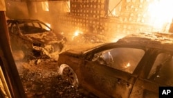 Burnt-out cars after a Russian attack on a residential neighborhood in Kharkiv, Ukraine, Feb. 10, 2024.