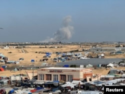 Smoke rises during an Israeli ground operation in Khan Younis, amid the conflict between Israel and the Palestinian Islamist group Hamas, as seen from a tent camp sheltering displaced Palestinians in Rafah, in the southern Gaza Strip, Feb. 21, 2024.