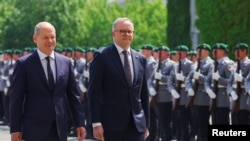German Chancellor Olaf Scholz and Australian Prime Minister Anthony Albanese review the troops in the yard of the Chancellery in Berlin, Germany, July 10, 2023. 