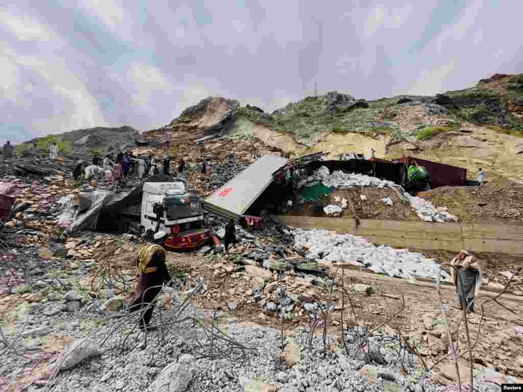 Tucks loaded with supplies are seen trapped in a landslide on the road close to the Torkham border, Pakistan.