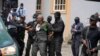 Nigeria Department of State Services has a misunderstanding with the Nigeria correctional service officer, center, during a court hearing with Godwin Emefiele, suspended Central Bank governor, at the Federal High Court in Lagos, Nigeria, July. 25, 2023.