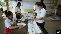 Polling station workers count ballots at Toul Snoa primary school outside Phnom Penh, Cambodia, July 23, 2023.