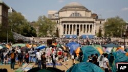 FILE - Student protesters gather inside their encampment on the Columbia University campus, on April 29, 2024, in New York.